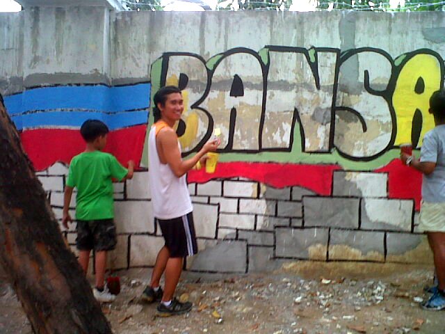 The author, getting his hands dirty on the walls of Camp Aguinaldo